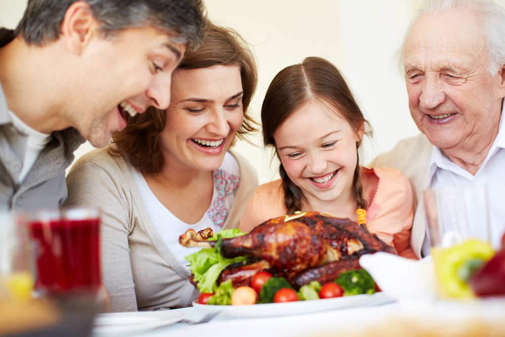 Family sharing Thanksgiving meal.