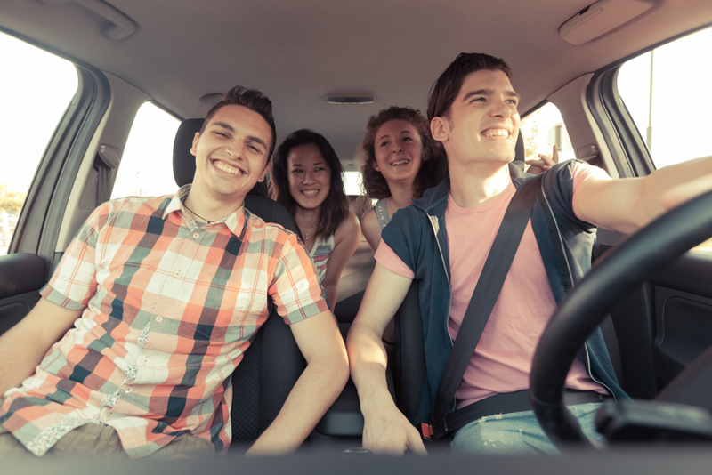 Four Friends Driving On a Summer Road Trip